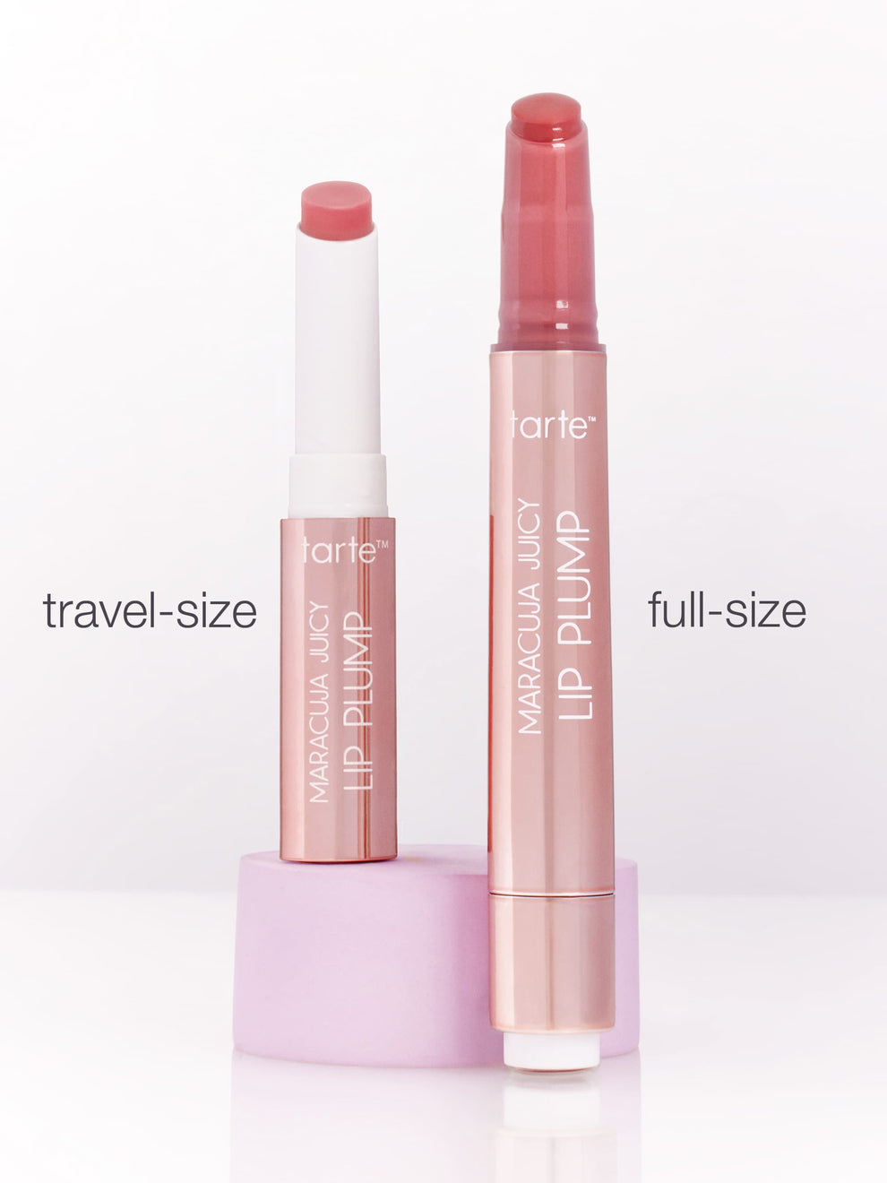 Two Tarte Cosmetics Maracuja Juicy Lip Plump tubes stand upright, showcasing travel-size and full-size versions. The background is a clean, white surface with travel-size and full-size labels.