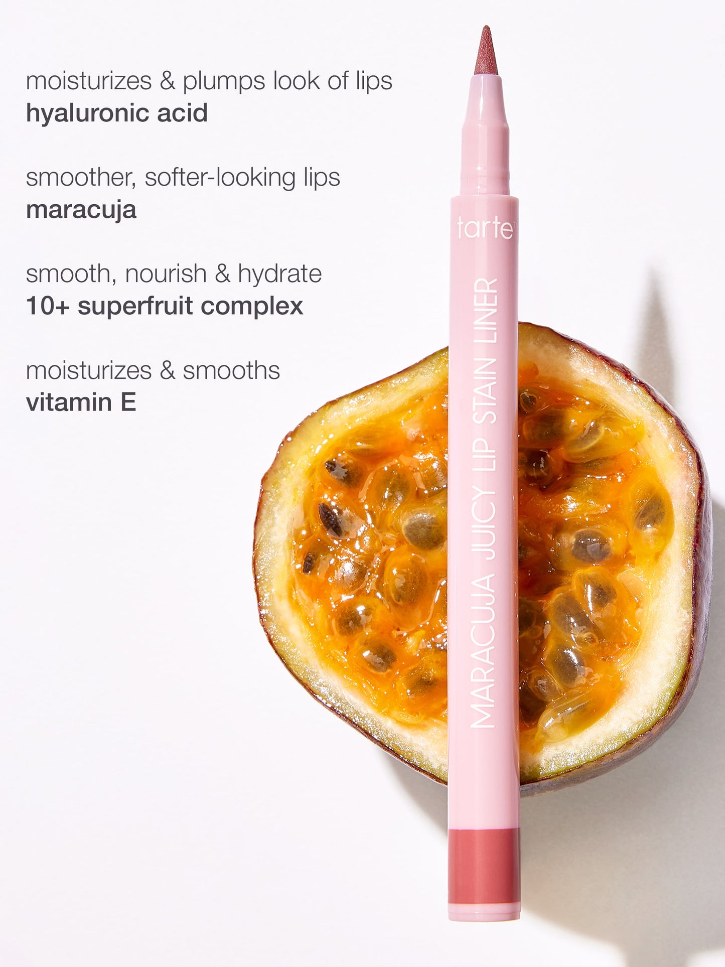 Pink lip liner with a passion fruit next to it on a white background