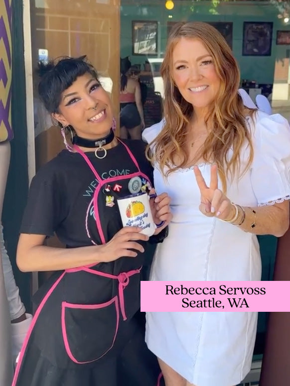 Two people stand smiling. One wears a black apron, holding a cup with coffee and weed printed. The other person in a white dress shows a peace sign. Text: Rebecca Servoss Seattle, WA.
