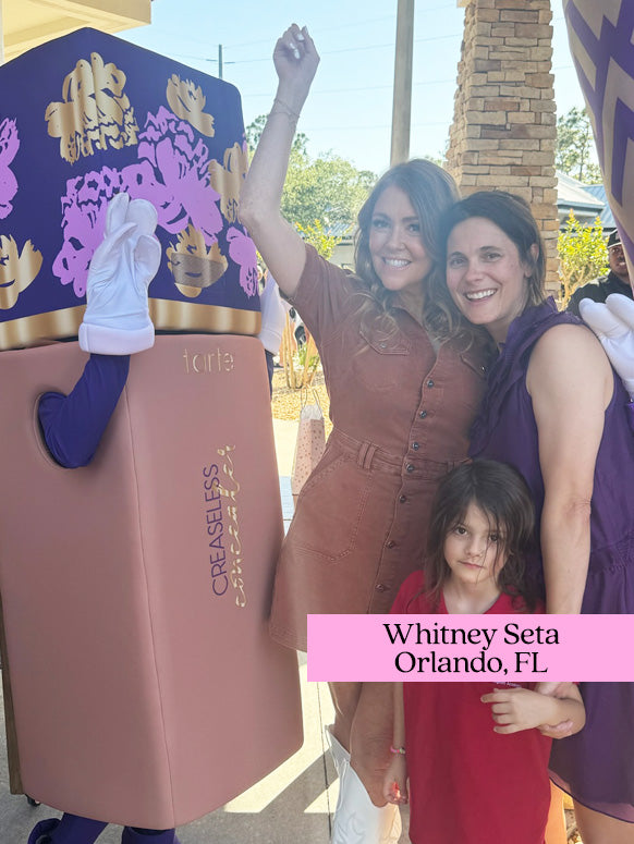 A person in a large Tarte Cosmetics creaseless concealer costume raises an arm beside two adults and a child outdoors. Text: tarte CREASELESS concealer Whitney Seta Orlando, FL appears on the costume and image.