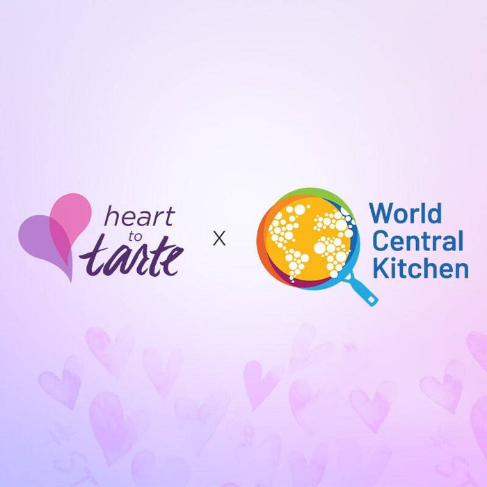 Two logos, heart to tarte and World Central Kitchen, are separated by an x on a light purple background with faint heart patterns.
