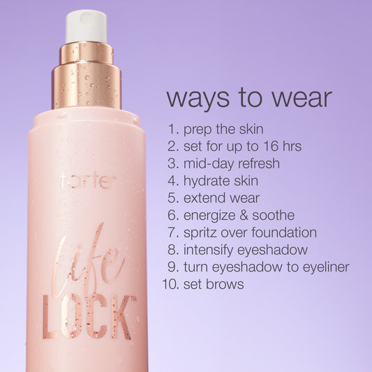 A spray bottle labeled Tarte life LOCK stands with water droplets, against a purple background. Text lists ways to wear, including skin preparation, setting makeup, and enhancing eyeshadow.