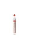Lip oil with a white cap on a light pink background