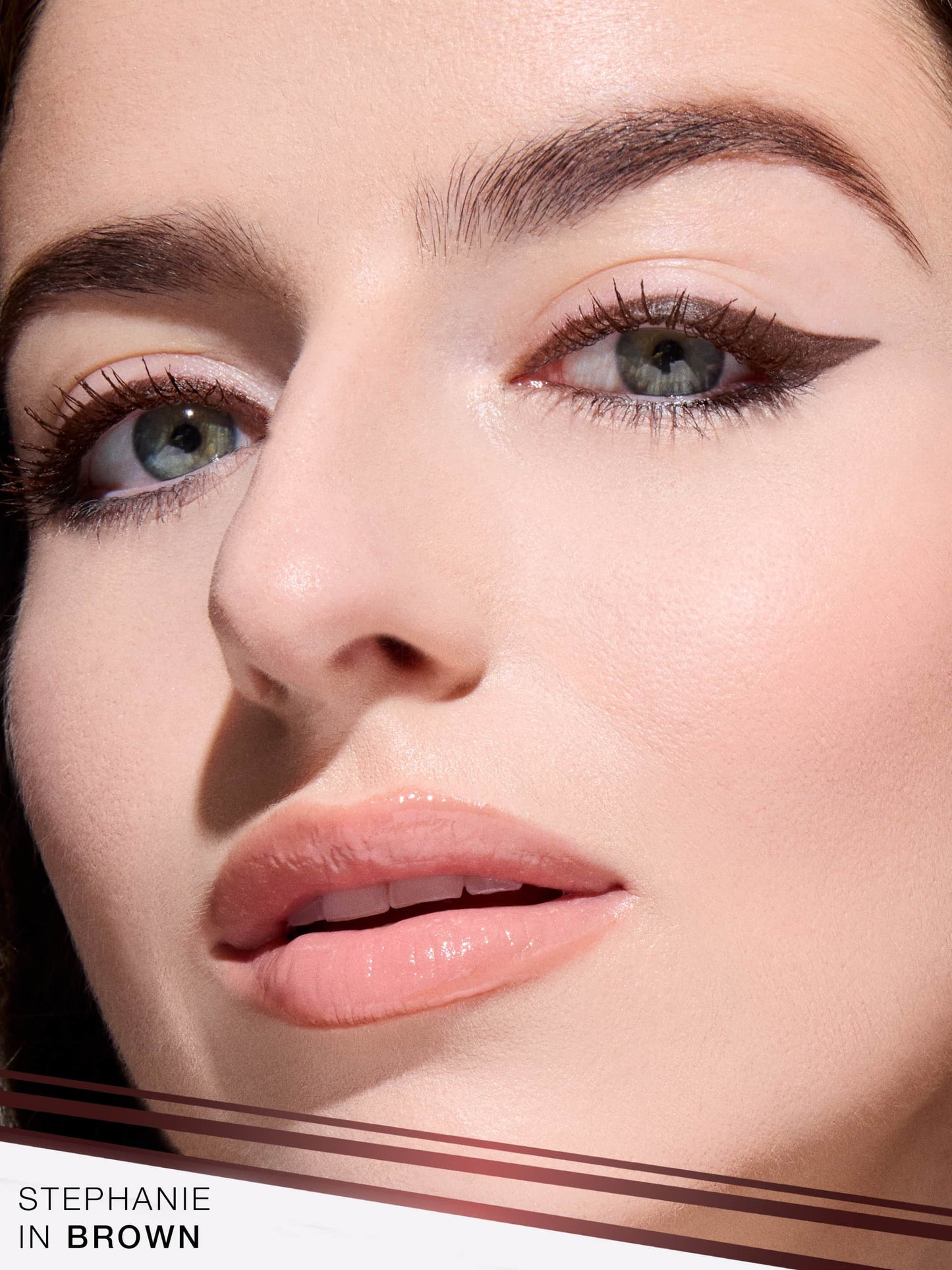 Close-up of a woman's face with eyeliner being applied, featuring the brand 'Stephanie'.