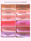 Lip gloss swatches, shown horizontally, display different shades labeled: honeysuckle, honeysuckle shimmer, daisy pink, daisy pink shimmer, cherry blossom, cherry blossom shimmer, hibiscus, hibiscus shimmer, carnation, carnation shimmer, marigold, marigold shimmer against a plain background. Text above reads: maracuja juicy lip plumping oil shimmer.