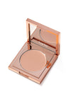 Rose-gold Tarte compact sits open, revealing a round pressed-powder pan and mirrored lid reflecting the tarte logo, set on a plain white background. Text in image: tarte